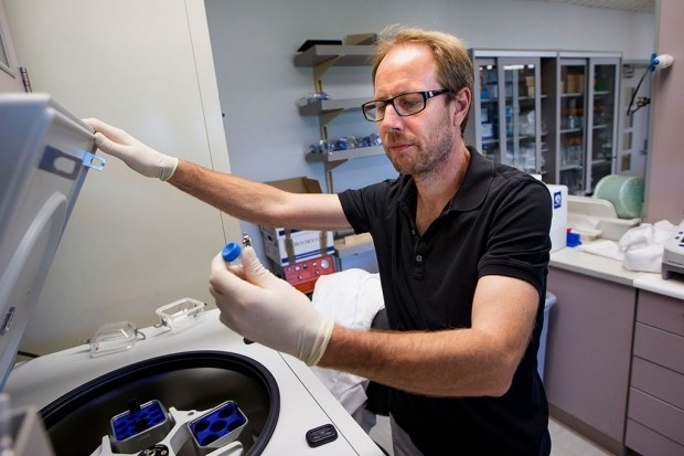 Tony Wyss-Coray examines a lab sample.